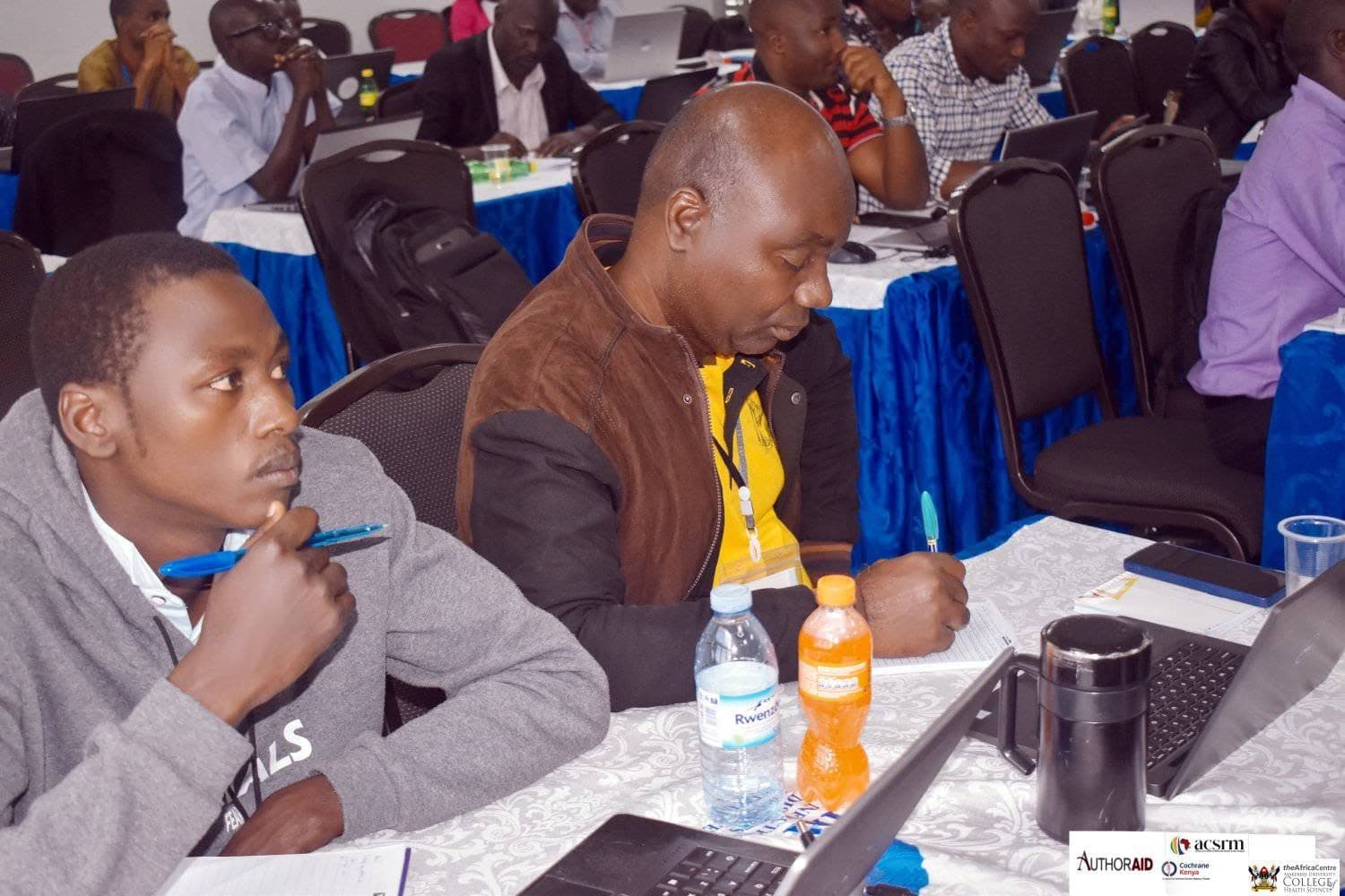 Workshop participants discussing evidence-synthesis work at a table.
